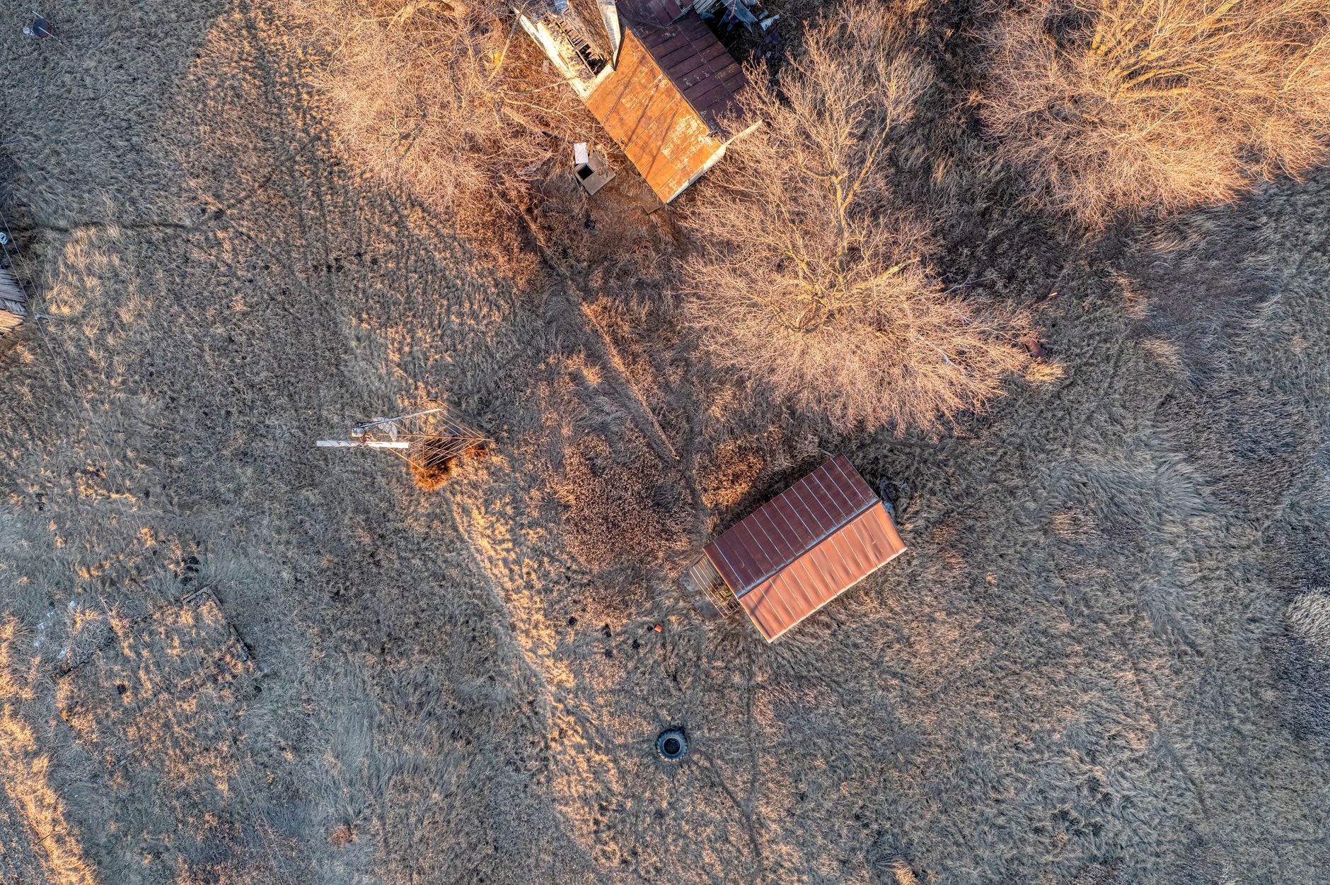 Winter aerial view of rural farm buildings with bare trees in Minnesota.