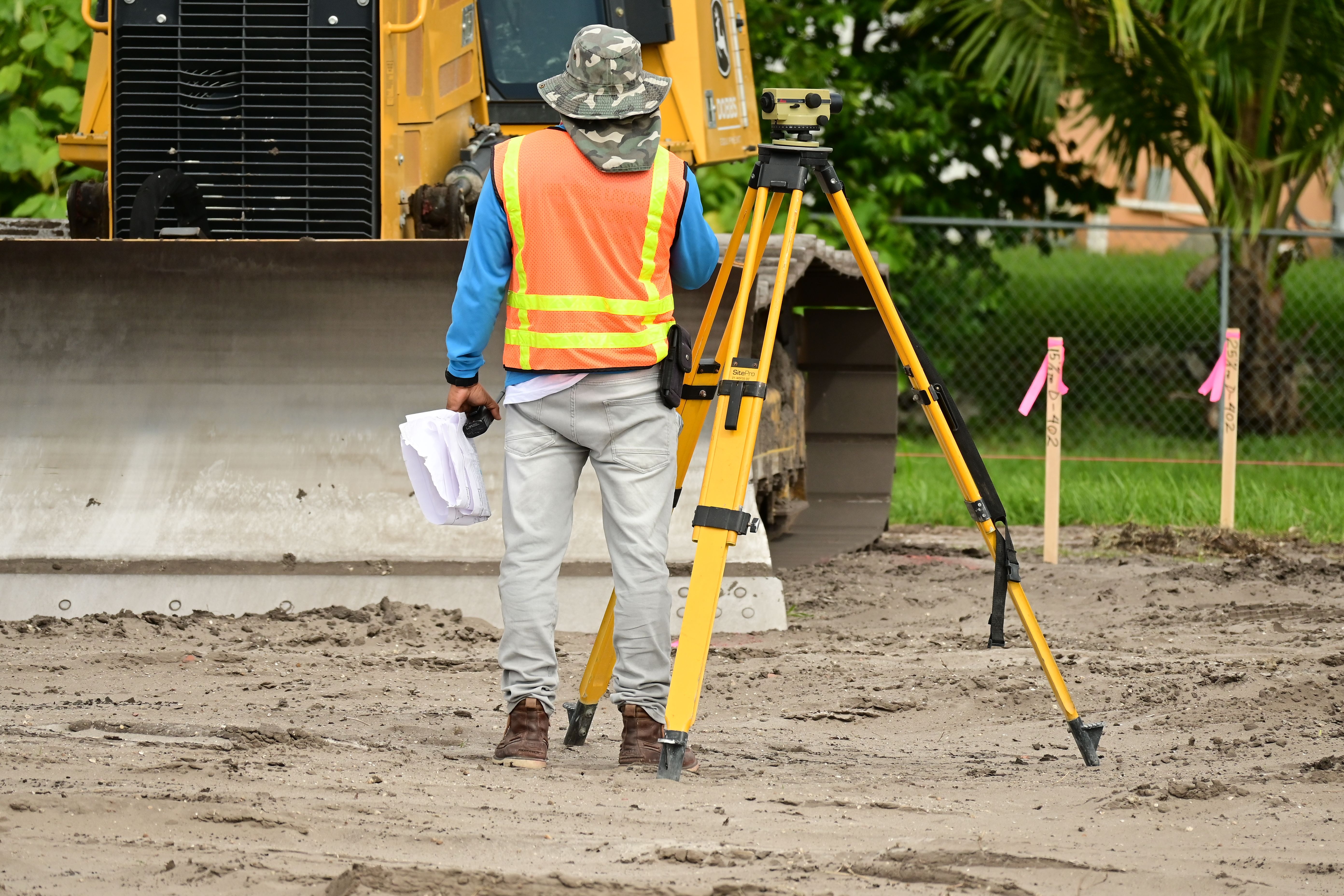 Land surveyor measuring a construction site